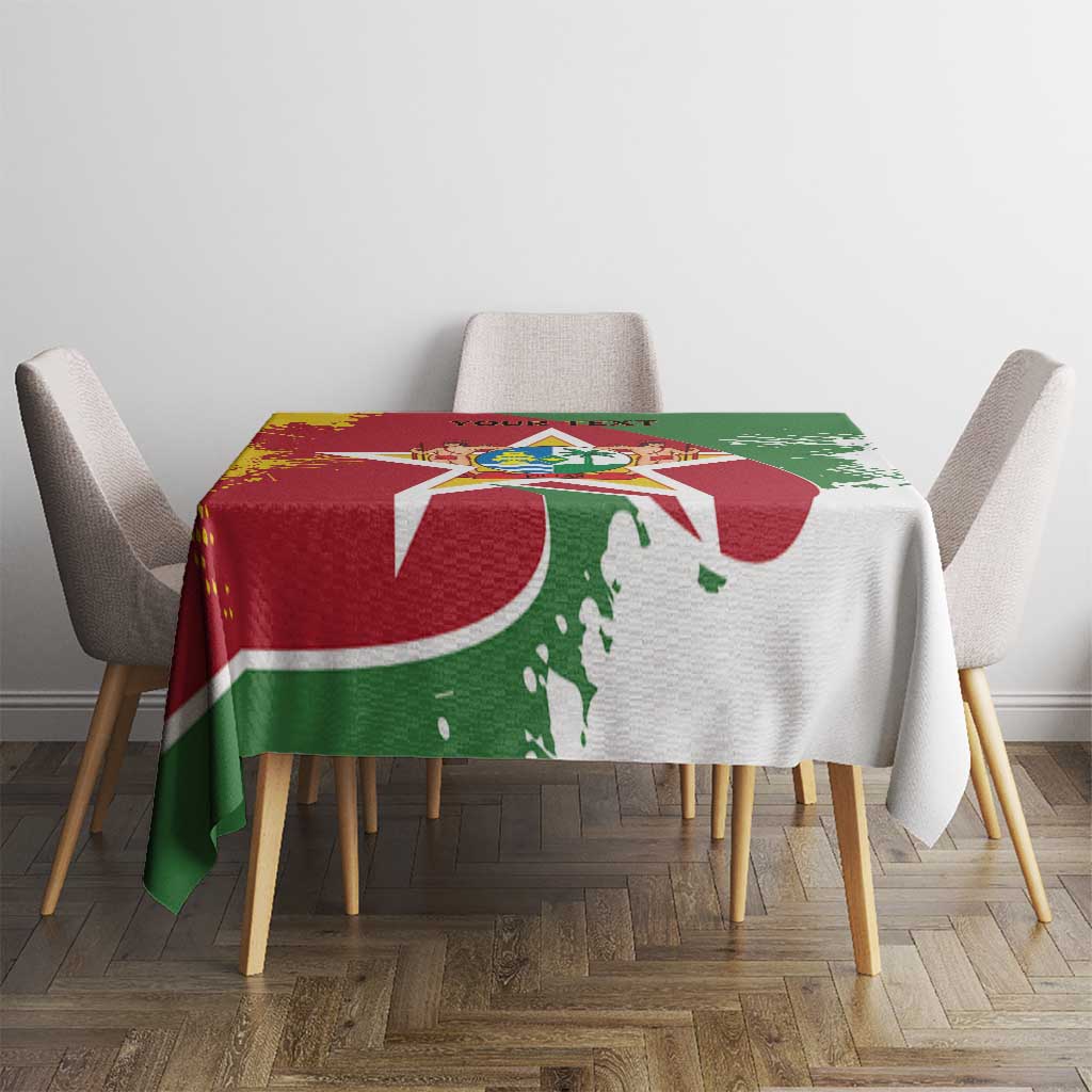 Suriname flag-style tablecloth on small table, red green and white emblem pattern