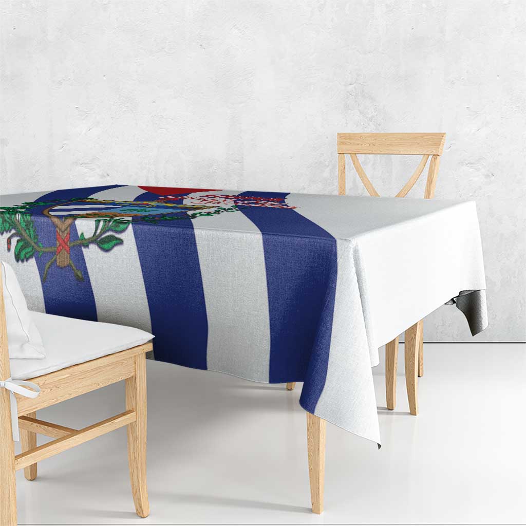White tablecloth with blue striped band and Cuban crest, draped over table edge