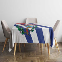 White tablecloth with blue-and-white stripes and Cuban emblem, on dining table