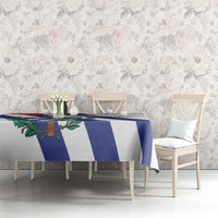 White tablecloth with blue-and-white stripes and Cuban emblem on dining table
