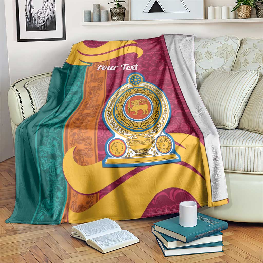 Colorful lion emblem blanket draped on couch, maroon teal and gold pattern.