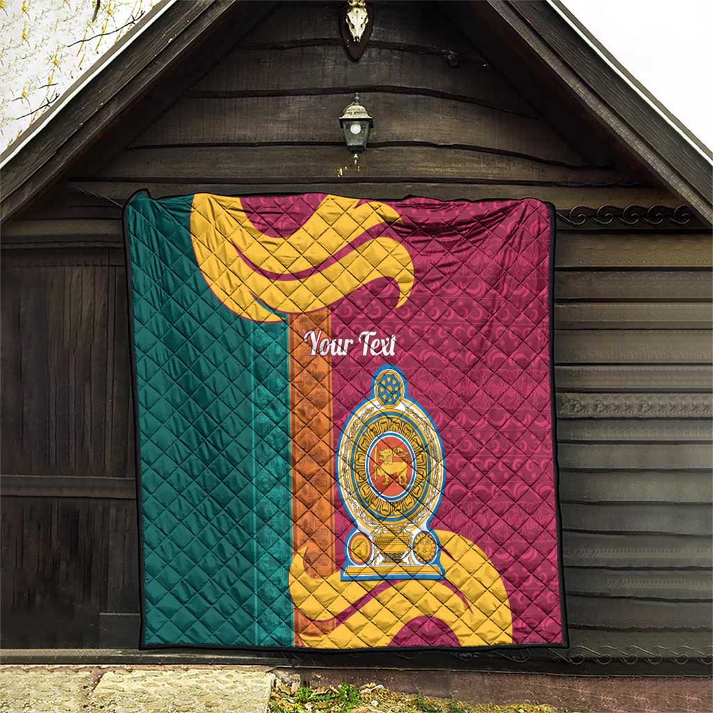 Teal and maroon quilt featuring gold crest emblem and curving scroll, diamond quilted.