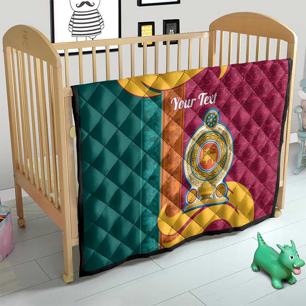 Teal and maroon quilt on wooden crib with gold crest emblem and diamond quilting.