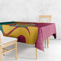 Maroon tablecloth with gold and teal patterned panels, hanging over table edge.