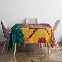 Maroon tablecloth with colorful ornate print, covering square dining table.