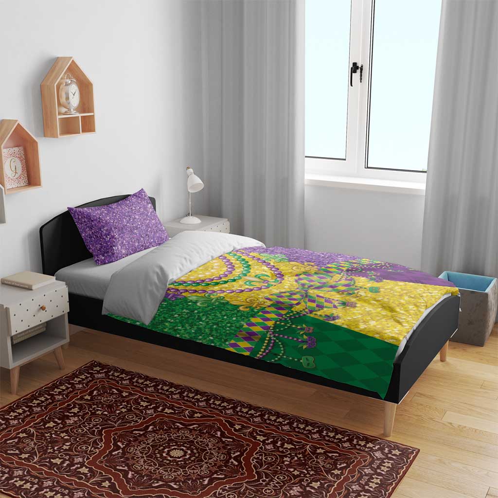 Mardi Gras bedding set on bed with purple glitter pillows and green-yellow purple fleur-de-lis print
