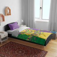 Mardi Gras bedding set on bed with purple glitter pillows and green-yellow purple fleur-de-lis print