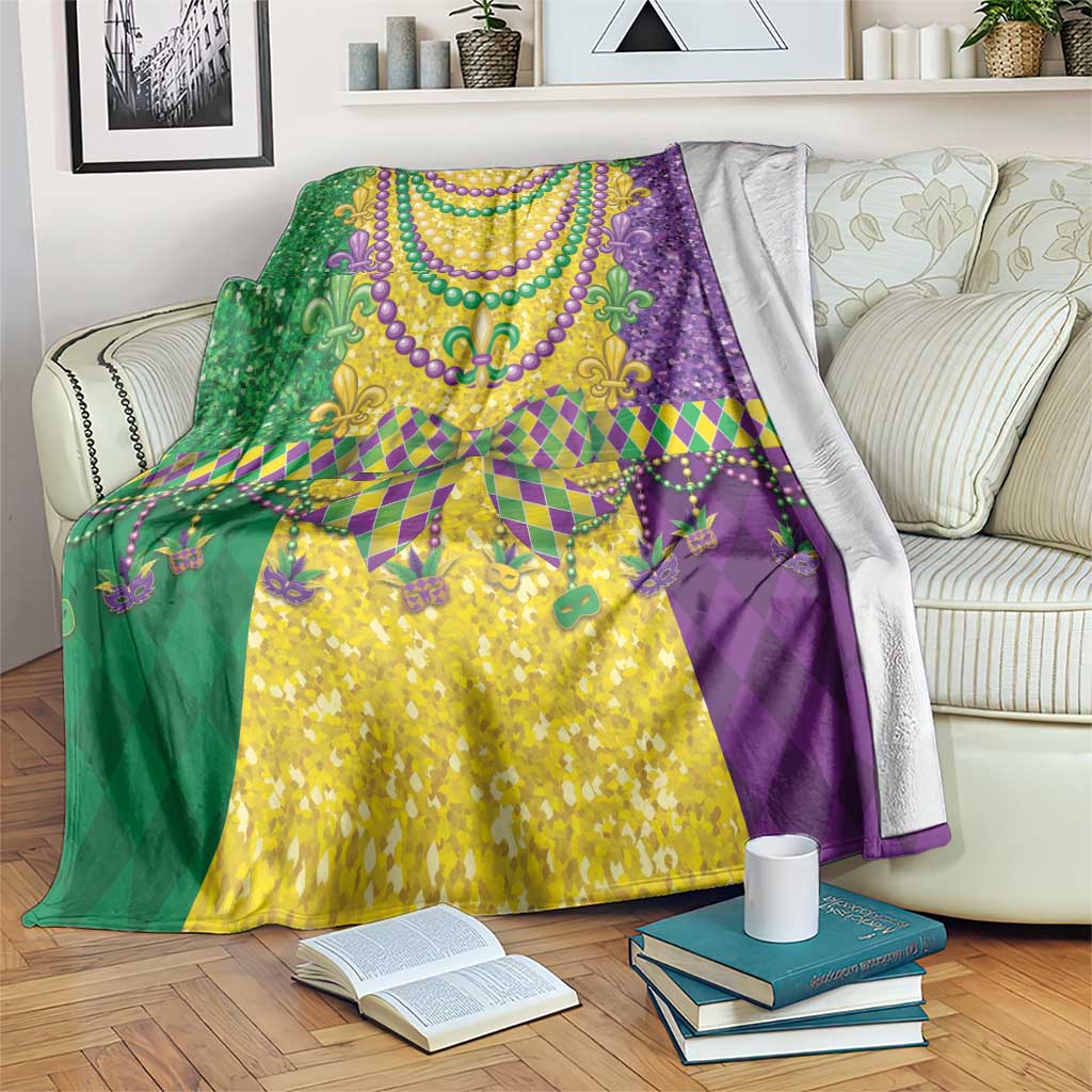 Mardi Gras throw blanket with purple, green, and gold fleur-de-lis bead design