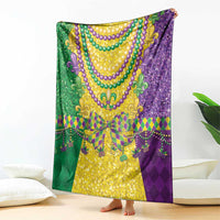 Mardi Gras blanket draped in purple and green with gold centerpiece and bead trim