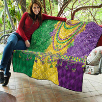 Mardi Gras fleur-de-lis quilt held outdoors, green yellow and purple beaded medallion center