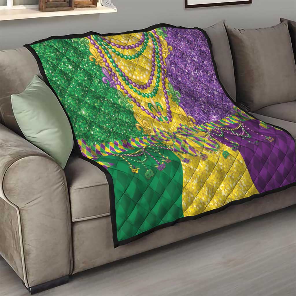 Mardi Gras fleur-de-lis quilt draped on sofa in green, yellow, and purple with bead details