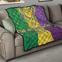 Mardi Gras fleur-de-lis quilt draped on sofa in green, yellow, and purple with bead details