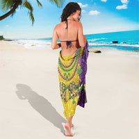 Mardi Gras glitter sarong with bead fringe and fleur-de-lis print in gold and purple