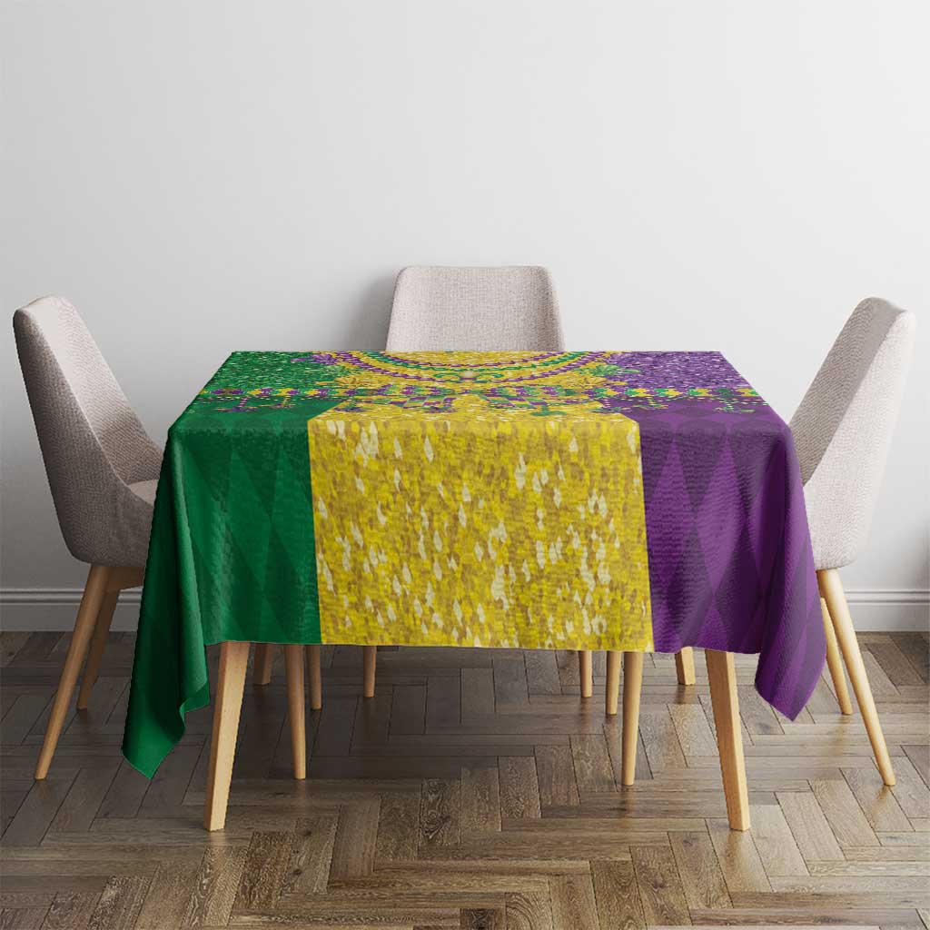Mardi Gras tablecloth on table with purple, green, and gold sections and beaded motifs