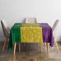 Mardi Gras tablecloth on table with purple, green, and gold sections and beaded motifs