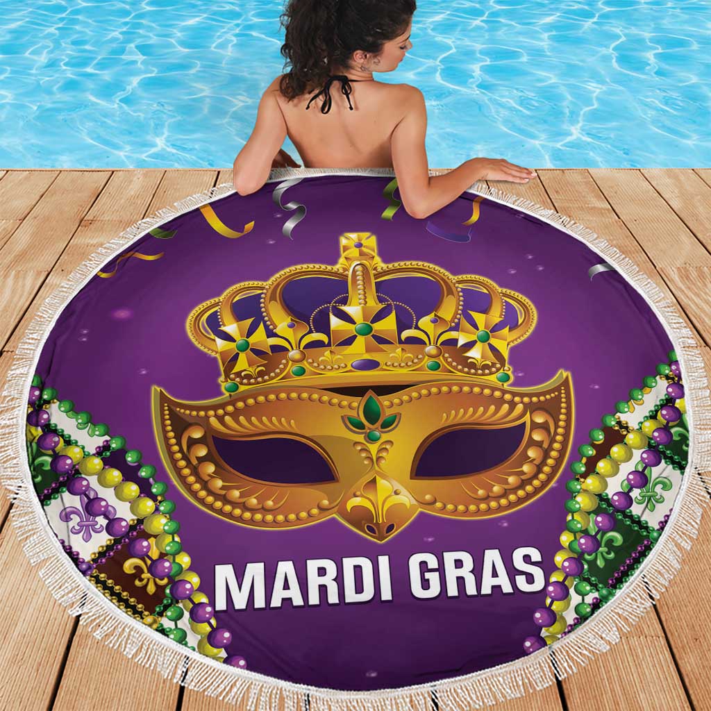 Purple Mardi Gras beach blanket on wooden deck with gold crown mask and white fringe