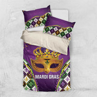 Purple king bedding set with two pillows and gold Mardi Gras mask, crown, and fleur-de-lis diamonds