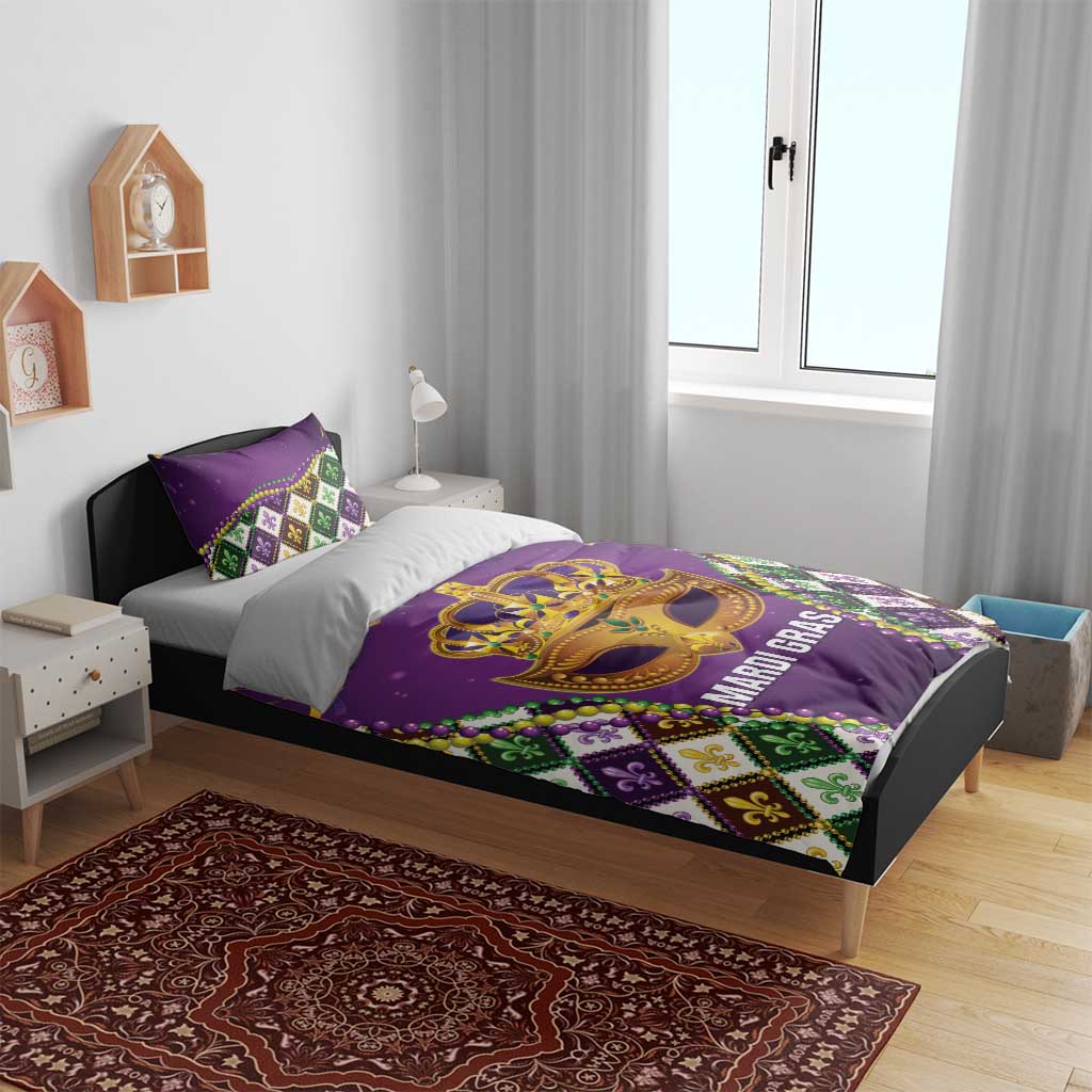 Purple king bedding set on bed with gold Mardi Gras mask center and fleur-de-lis diamond accents