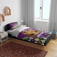Purple king bedding set on bed with gold Mardi Gras mask center and fleur-de-lis diamond accents