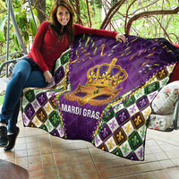 Purple quilt held outdoors with gold crown mask and 'MARDI GRAS' text, fleur-de-lis border