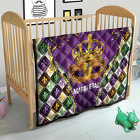 Purple quilt in wooden crib with gold crown mask and 'MARDI GRAS' text, fleur-de-lis border