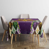 Purple tablecloth with centered gold crown graphic and multicolor diamond border