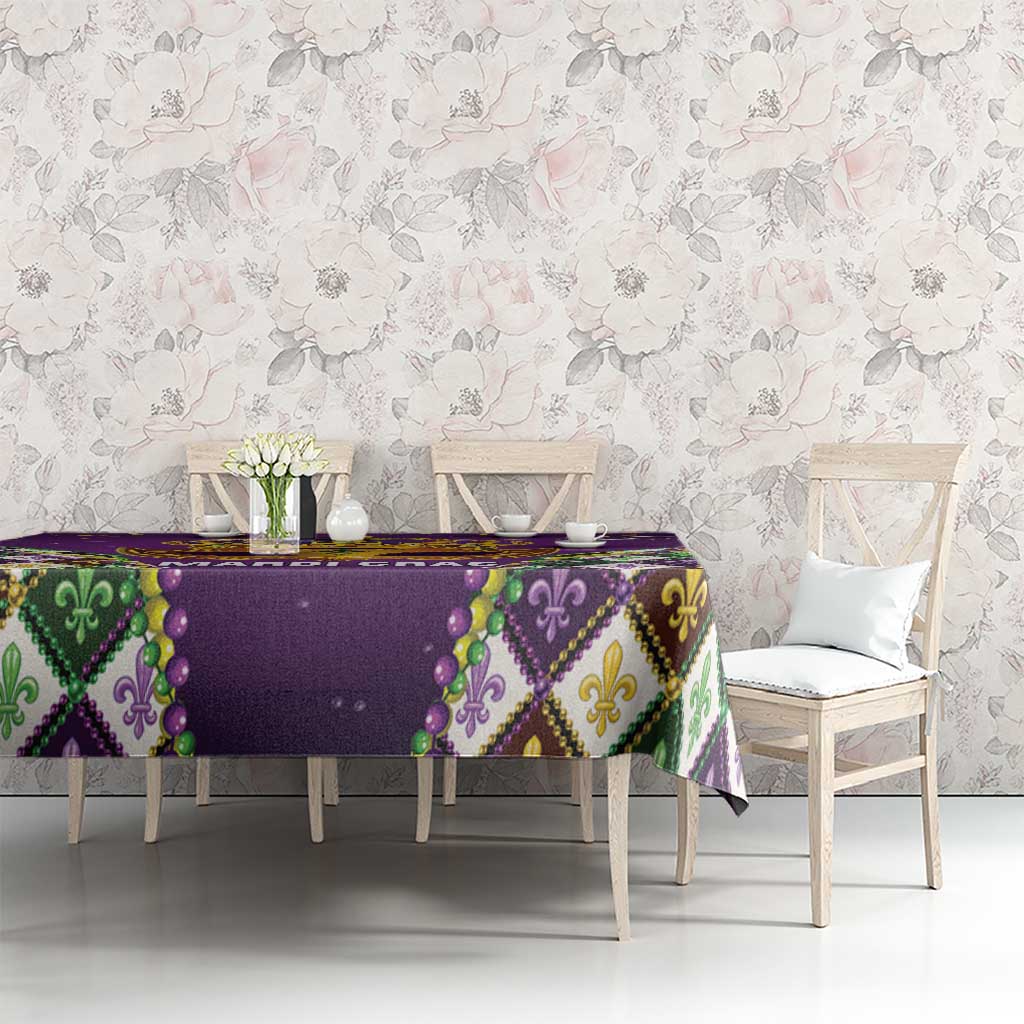 Purple tablecloth with gold bead trim and multicolor diamond pattern on dining table