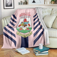 Pink blanket with navy-and-white diagonal stripes and coat-of-arms crest graphic