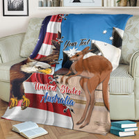 Personalized blue blanket draped on couch with eagle, kangaroo, and custom text