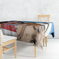 Blue tablecloth draped over table edge with eagle and kangaroo print
