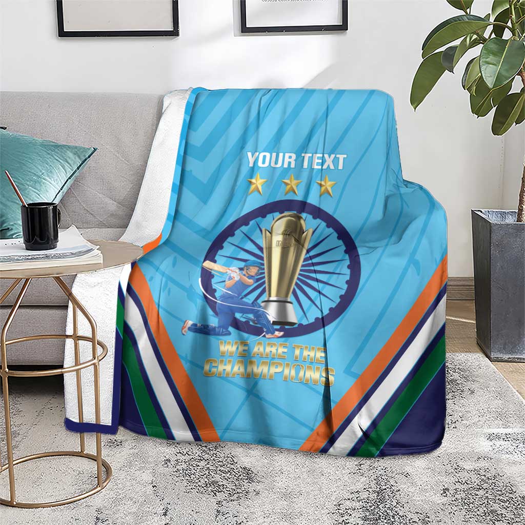 Blue cricket throw blanket on floor with trophy emblem and multicolor V stripes