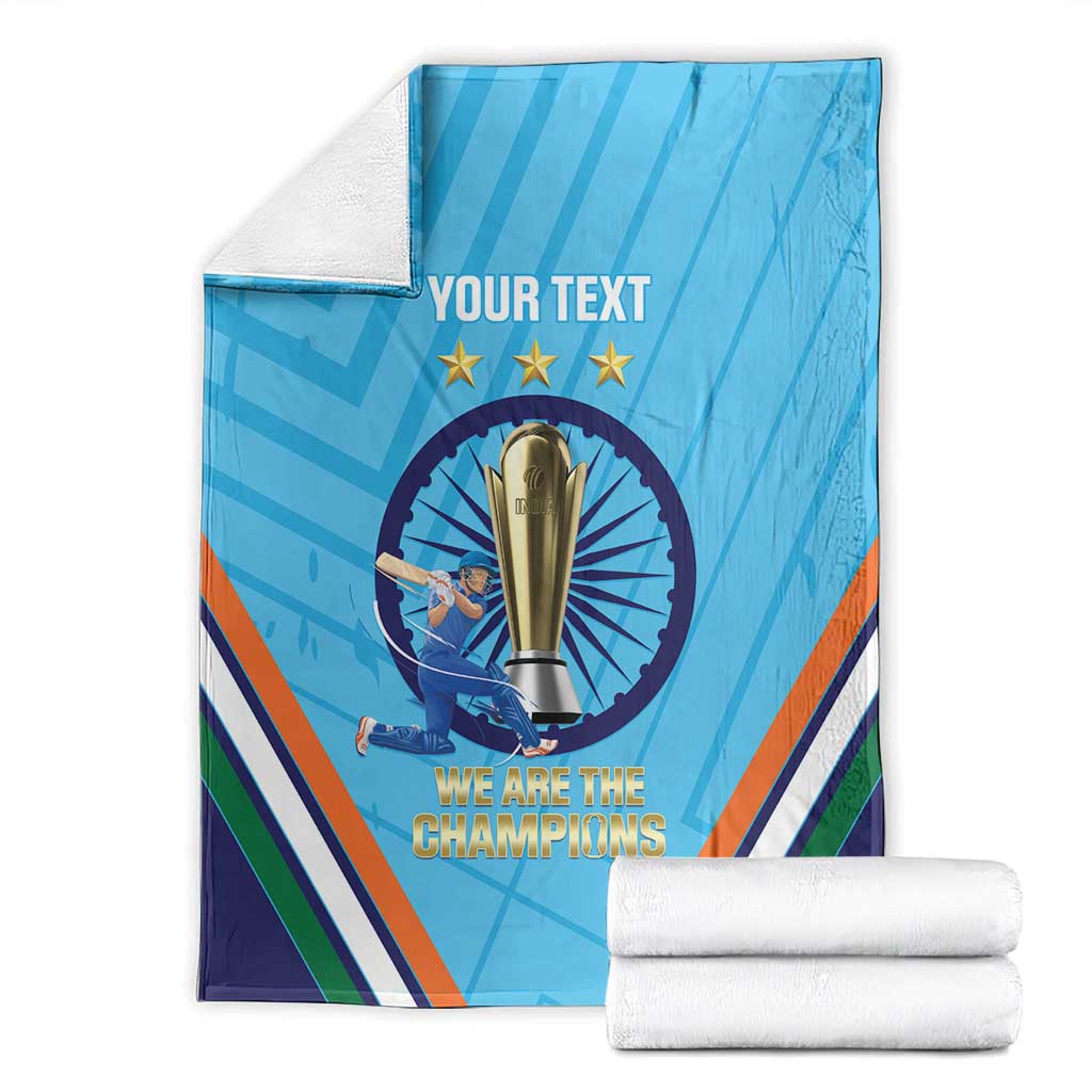 Blue cricket throw blanket folded stack with trophy emblem, stars, and 'We are the Champions'