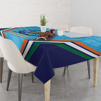 Blue tablecloth with trophy image, multicolor stripes, and dark blue draped edge