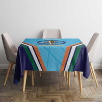 Blue tablecloth on dining table with trophy emblem and multicolor stripe pattern