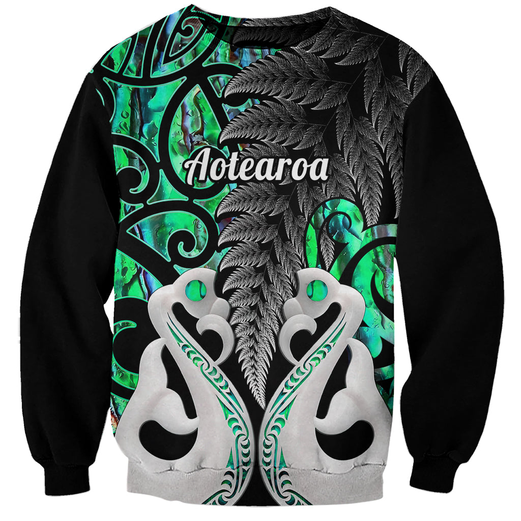 Personalized green sweatshirt with Aotearoa graphic, black feathers, white hearts