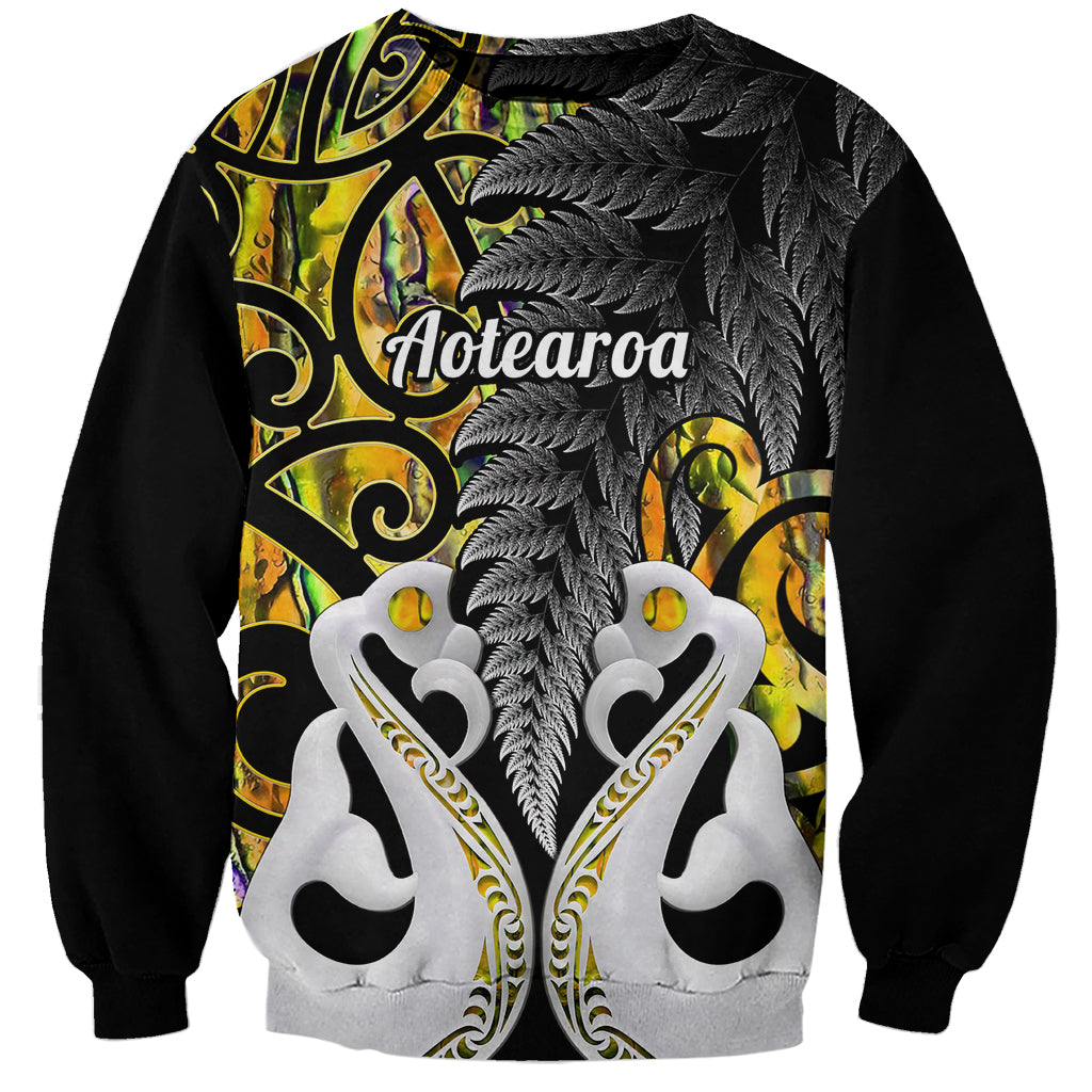 Unisex sweatshirt: black sleeves, gold fern and maori artwork with Aotearoa text