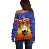 Blue off-shoulder sweater, back view, tribal gradient pattern with "YOUR TEXT" block