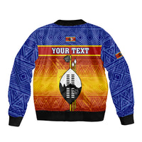 Unisex blue zip-up bomber jacket with African pattern and shield graphic, 'YOUR TEXT'
