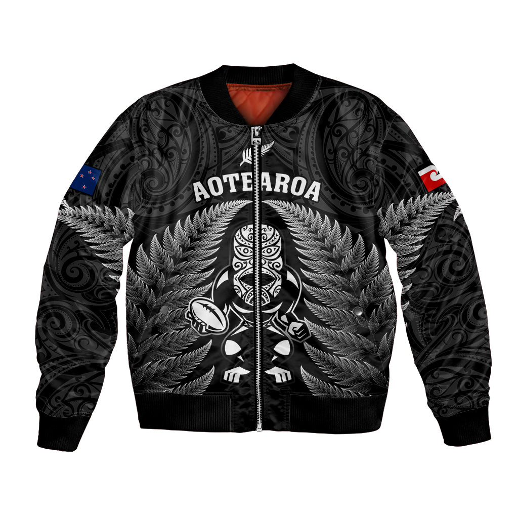Black bomber jacket with zip front and fern tiki graphic, AOTEAROA lettering