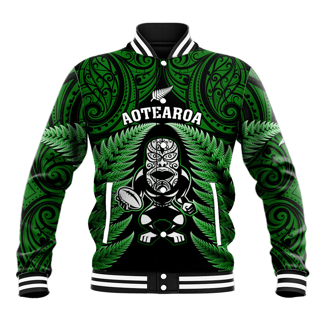 Green varsity baseball jacket with Maori fern print, tribal emblem, striped ribbed collar and cuffs.