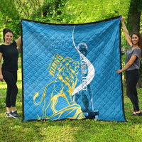 Blue quilt with Saint Lucia Kings gold lion emblem and oval graphic, diamond stitching