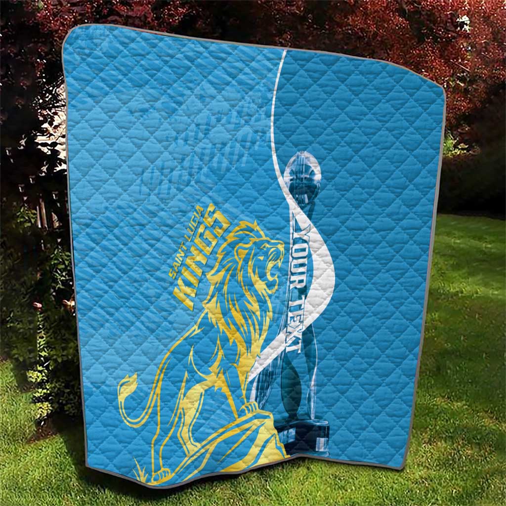 Blue quilt blanket featuring Saint Lucia Kings gold lion and oval logo on quilted fabric