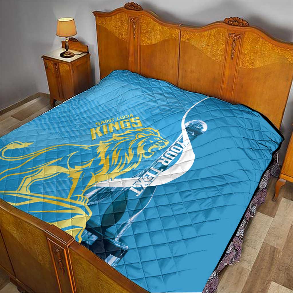 Blue quilt laid over bed with Saint Lucia Kings gold lion, oval design, diamond stitching