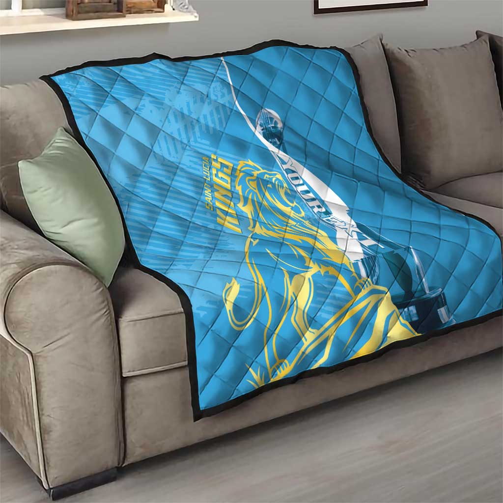 Blue quilt on sofa showing Saint Lucia Kings gold lion within white oval, diamond quilting