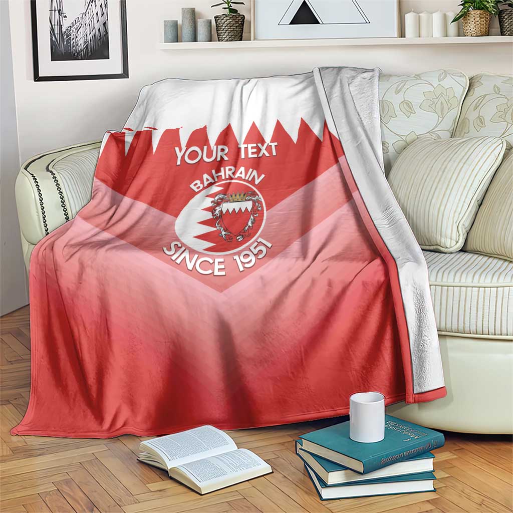 Red and white football blanket with Bahrain crest, zigzag top, and 'Since 1951' text