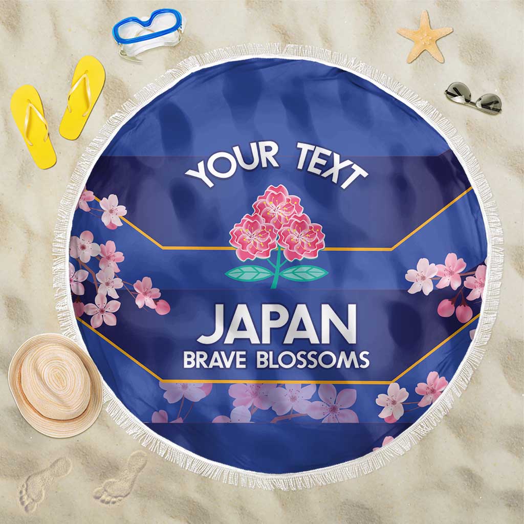 Blue round beach blanket with white fringe, floral Japan print and 'YOUR TEXT' header