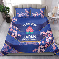 Blue bedding set on bed with duvet and two pillowcases, cherry blossom floral print
