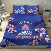 Blue bedding set with duvet and two pillowcases, pink cherry blossom and yellow trim