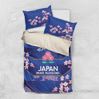 Blue bedding set with duvet and two pillowcases, pink cherry blossoms on front