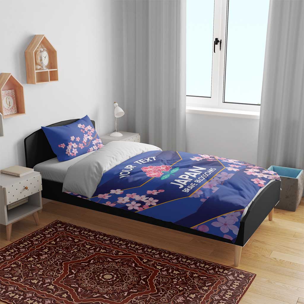 Blue bedding set with duvet and two pillowcases, cherry blossom motif in bedroom
